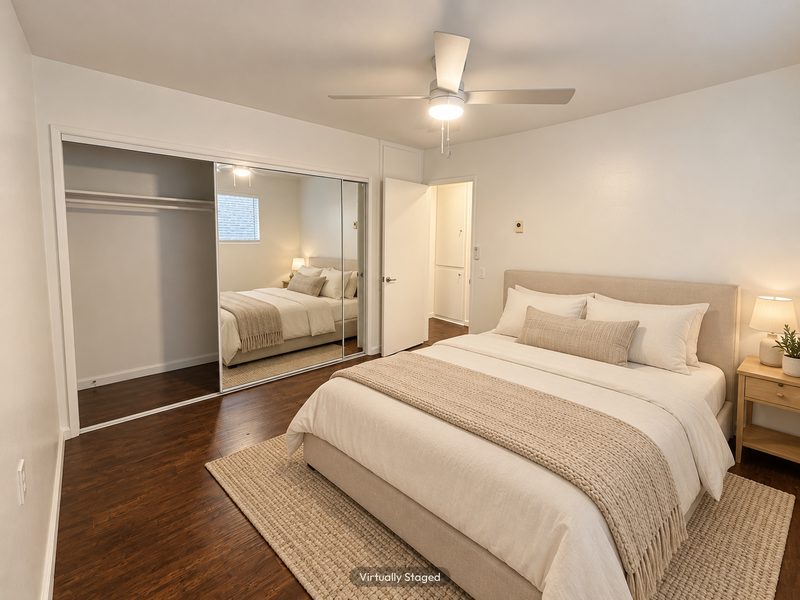 Unit C bedroom with mirrored closet, virtually staged