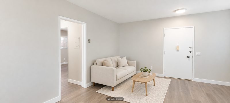 Unit D living room toward the entry, virtually staged