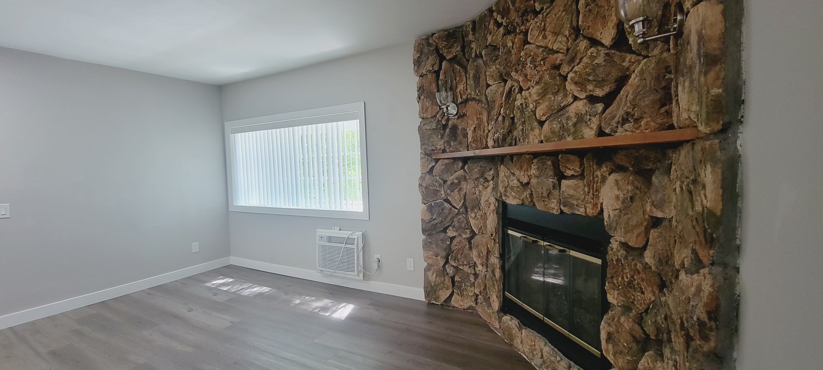Unit D living room, fireplace wall, original unaltered photo