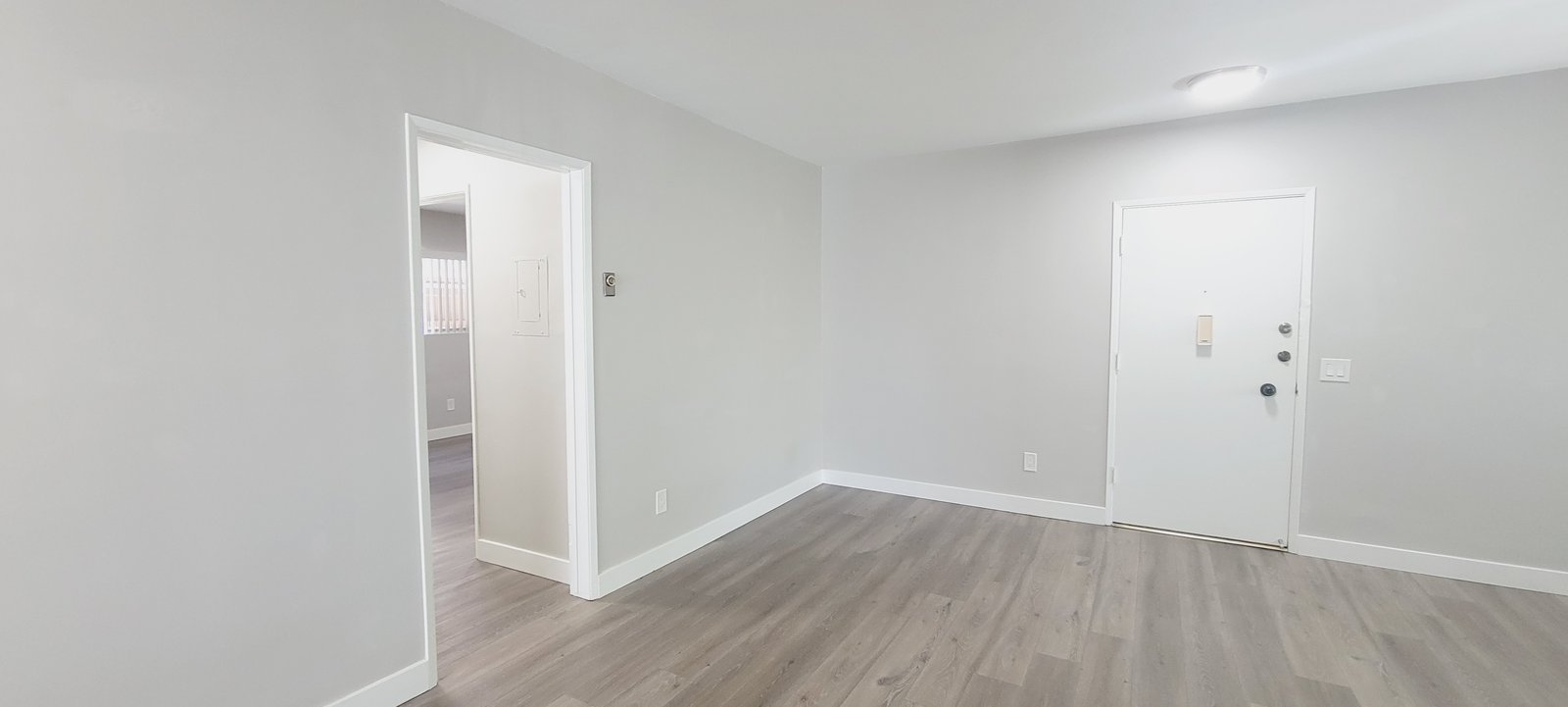 Unit D living room toward the entry, original unaltered photo