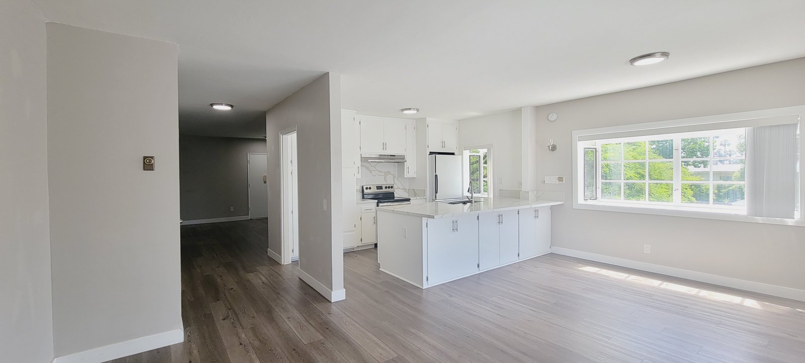 Unit D living area and kitchen, original unaltered photo