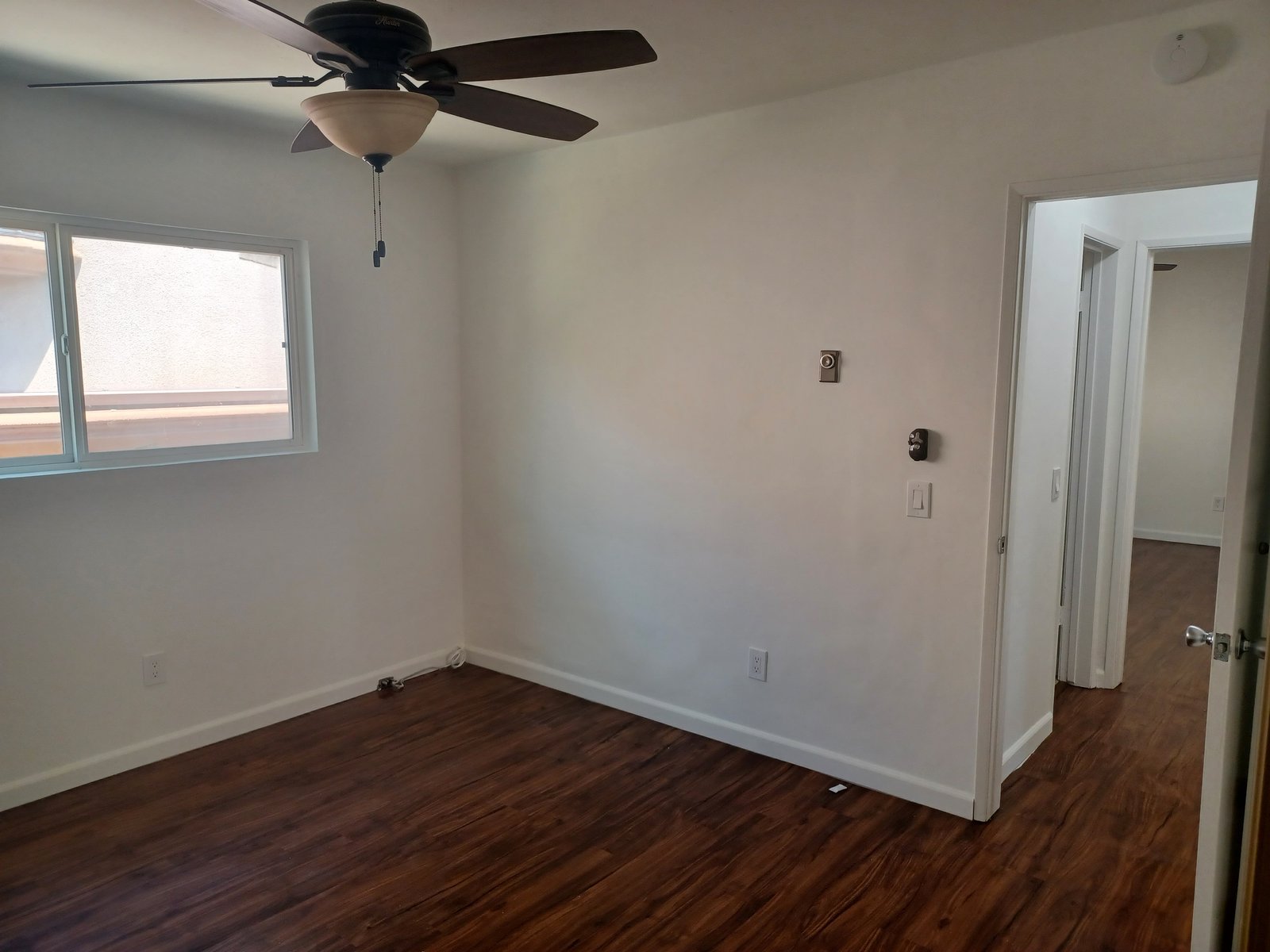 Unit E bedroom toward the hall, original unaltered photo